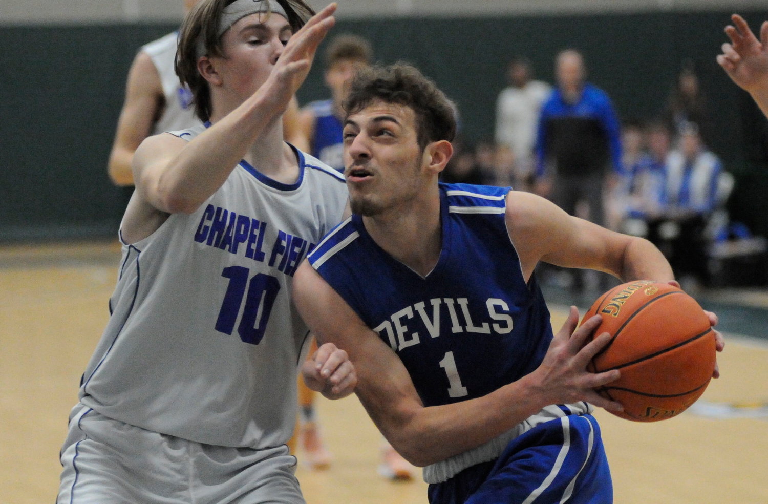 Looking at the ceiling. Roscoe’s Anthony Teipelice eyes the glass-backed rim against Chapel Field defender Leam Powell.